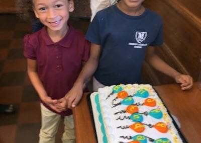 two girls smiling with Birthday cake at Sister Mary Hart program